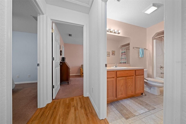 full bath with visible vents, toilet, shower / tub combo with curtain, tile patterned floors, and vanity