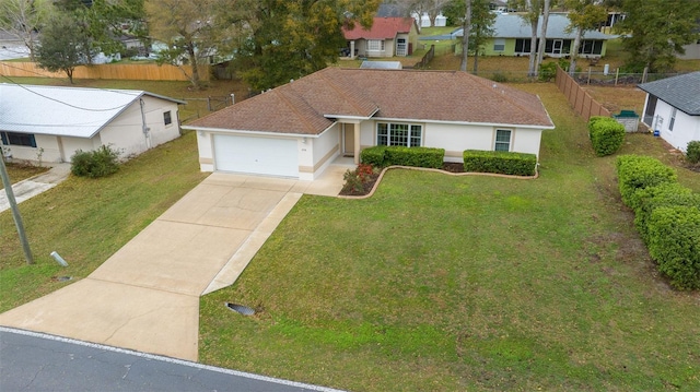 ranch-style house with driveway, a front lawn, an attached garage, and stucco siding