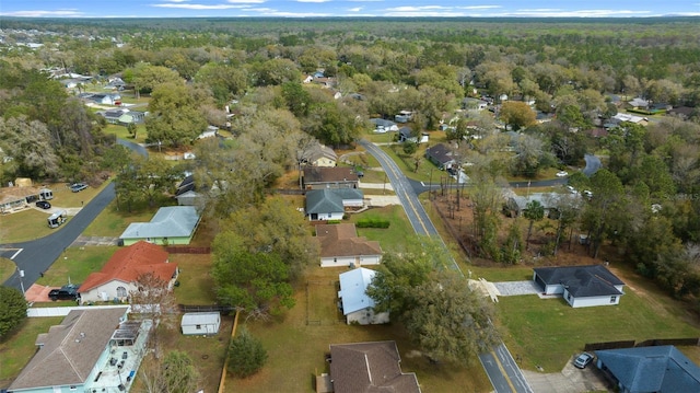 birds eye view of property with a forest view and a residential view