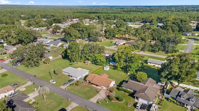 birds eye view of property featuring a forest view and a residential view