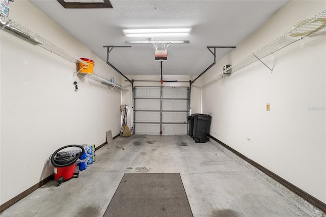 garage with a garage door opener and baseboards