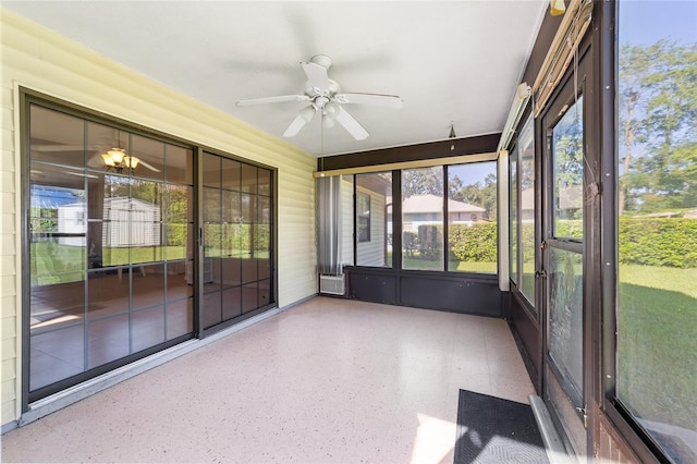 unfurnished sunroom featuring a ceiling fan