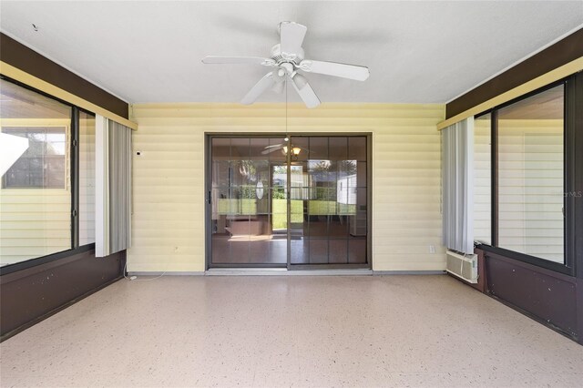 unfurnished sunroom featuring ceiling fan