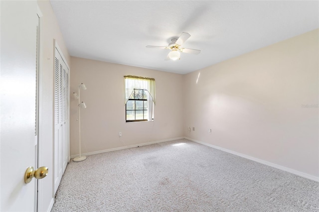 unfurnished bedroom featuring baseboards, light carpet, and ceiling fan