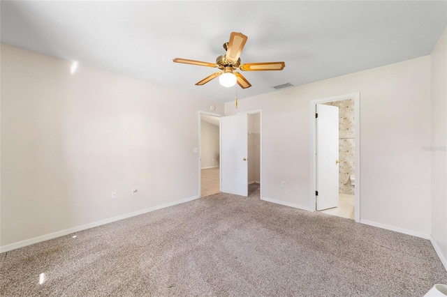 unfurnished bedroom featuring ceiling fan, carpet flooring, baseboards, and connected bathroom