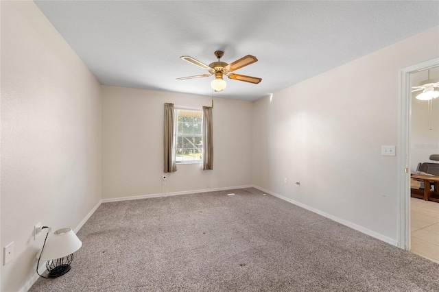 empty room with light carpet, baseboards, and ceiling fan