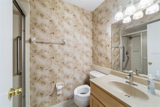 bathroom featuring wallpapered walls, vanity, and a stall shower