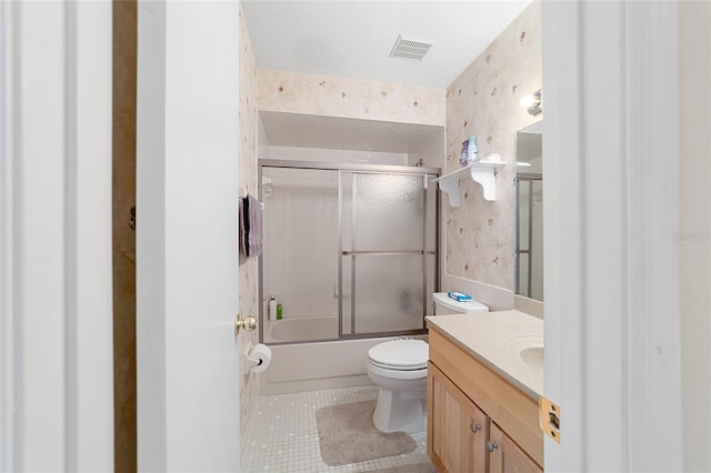 full bathroom featuring vanity, visible vents, bath / shower combo with glass door, tile patterned flooring, and toilet