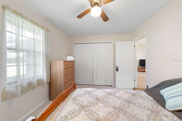 bedroom with a closet, multiple windows, baseboards, and ceiling fan