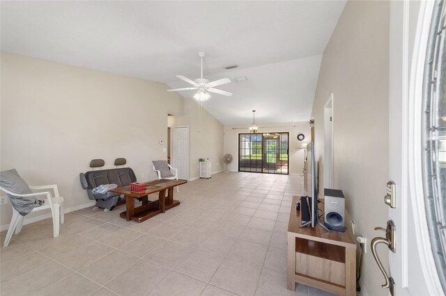 interior space with visible vents, ceiling fan, baseboards, lofted ceiling, and light tile patterned floors