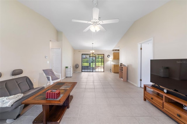 living area with light tile patterned floors, baseboards, high vaulted ceiling, and ceiling fan with notable chandelier