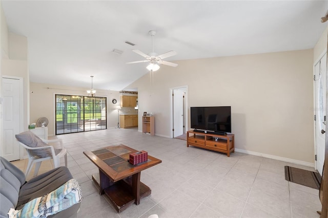 living area featuring visible vents, ceiling fan with notable chandelier, light tile patterned floors, baseboards, and vaulted ceiling