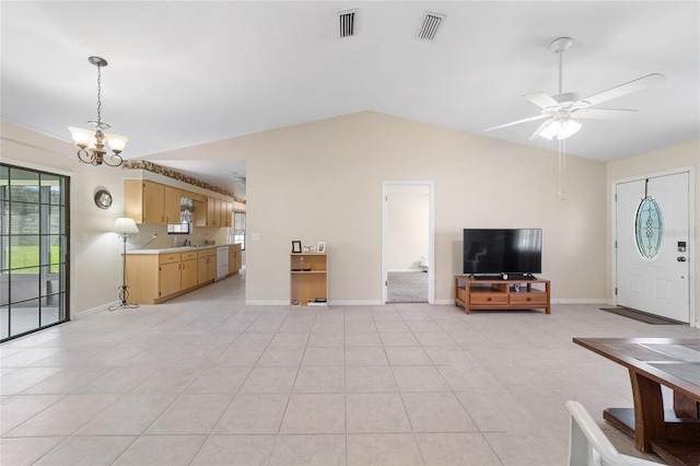 living area featuring light tile patterned flooring, visible vents, baseboards, and lofted ceiling