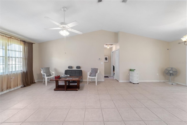 living area with visible vents, light tile patterned flooring, baseboards, ceiling fan, and vaulted ceiling