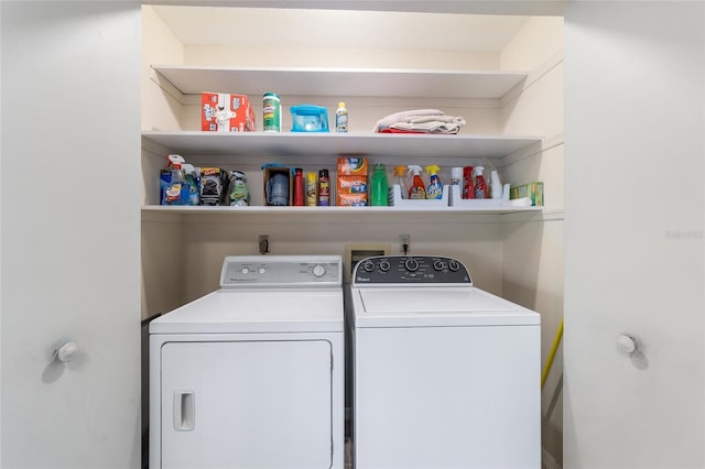 laundry room with washing machine and clothes dryer and laundry area