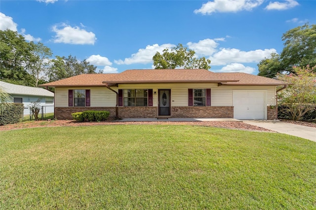 ranch-style home with fence, concrete driveway, a front yard, a garage, and brick siding