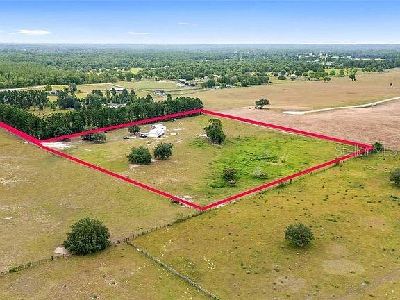 birds eye view of property with a rural view