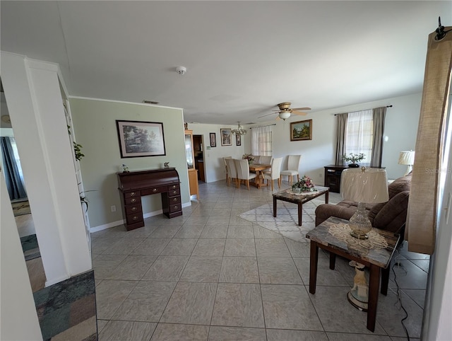 living room with tile patterned floors, visible vents, and a ceiling fan