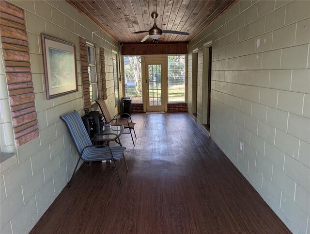 unfurnished sunroom with wooden ceiling and ceiling fan