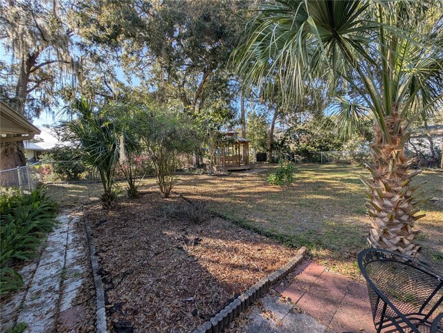 view of yard with a deck and fence