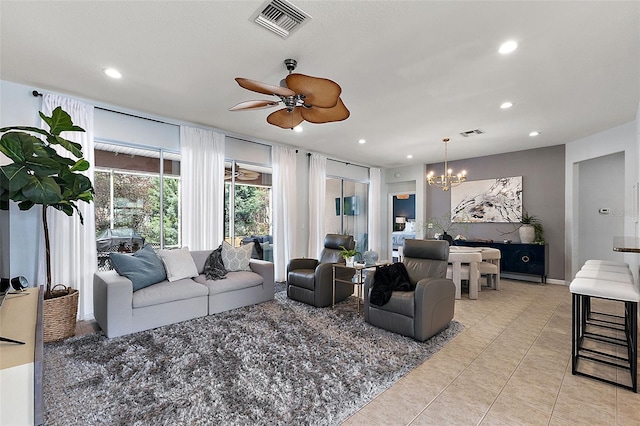 living room with ceiling fan with notable chandelier, light tile patterned floors, recessed lighting, and visible vents