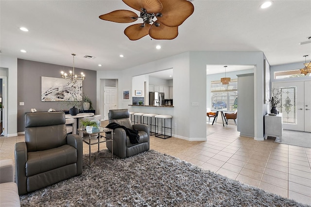 living room featuring visible vents, baseboards, light tile patterned floors, recessed lighting, and ceiling fan with notable chandelier