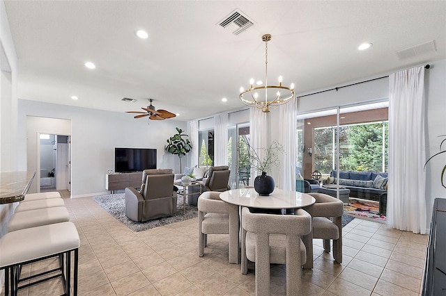 dining room featuring visible vents, light tile patterned flooring, and ceiling fan with notable chandelier