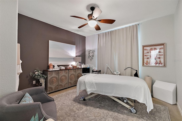 bedroom featuring light colored carpet and ceiling fan