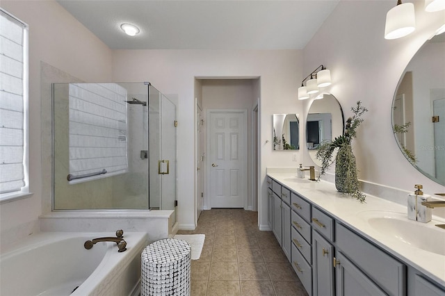 bathroom with a sink, a garden tub, a stall shower, and tile patterned flooring