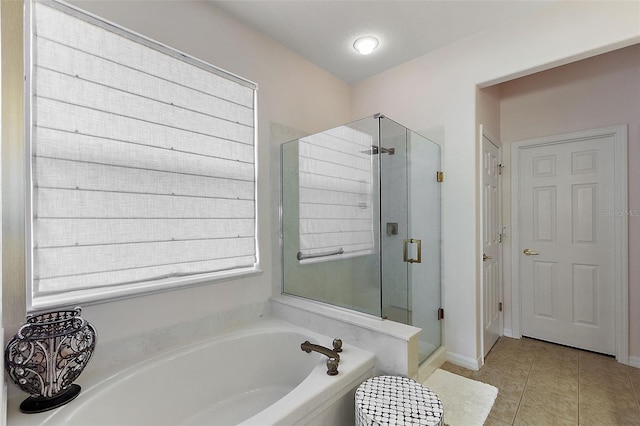 full bath featuring tile patterned floors, a bath, and a stall shower