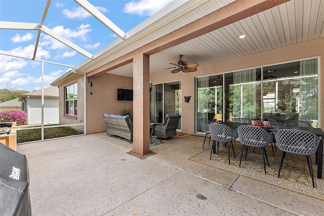 view of patio with a lanai, outdoor lounge area, and ceiling fan