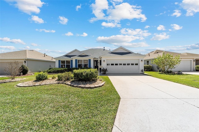 single story home featuring an attached garage, concrete driveway, and a front yard