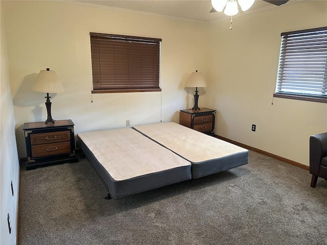 carpeted bedroom featuring baseboards and crown molding