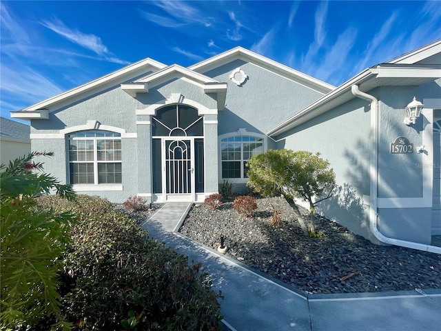 property entrance with stucco siding