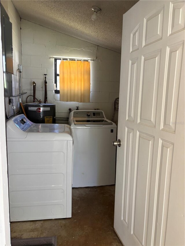 washroom with concrete block wall, laundry area, a textured ceiling, and electric water heater