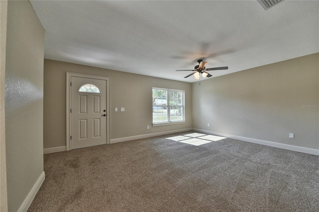 entryway with visible vents, baseboards, ceiling fan, a textured ceiling, and carpet flooring