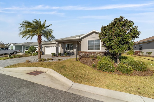 ranch-style house with a front lawn, a garage, driveway, and stucco siding