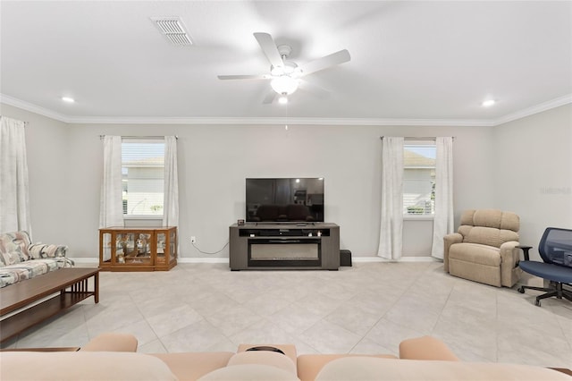 living area featuring light tile patterned floors, visible vents, baseboards, and crown molding