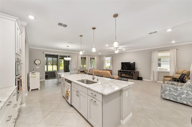 kitchen with a sink, visible vents, open floor plan, and crown molding