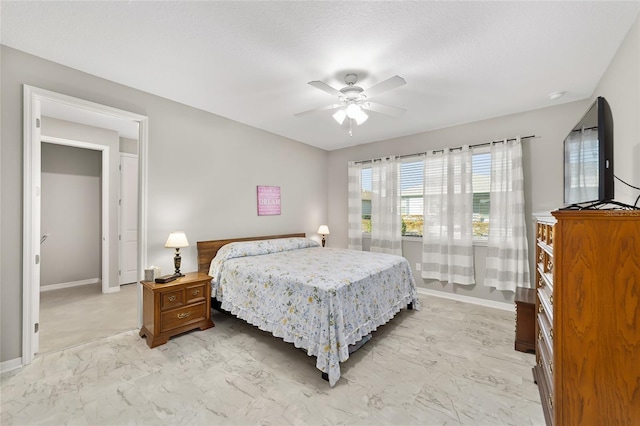 bedroom with marble finish floor, baseboards, and a ceiling fan