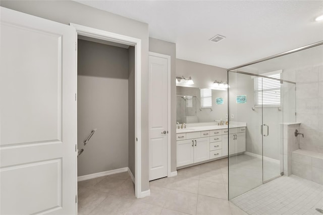 full bathroom with tile patterned flooring, a shower stall, double vanity, and visible vents