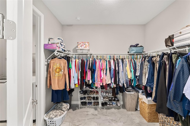 spacious closet with marble finish floor