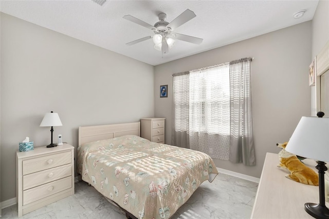 bedroom featuring baseboards, marble finish floor, and ceiling fan