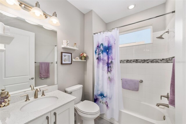 full bathroom featuring vanity, shower / tub combo, and toilet