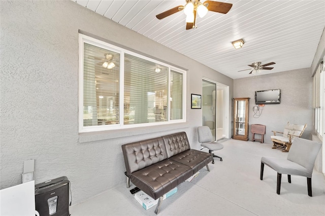 sunroom / solarium featuring ceiling fan