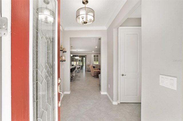 foyer featuring ornamental molding, baseboards, and light tile patterned floors