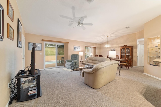 carpeted living room with lofted ceiling, ceiling fan, visible vents, and baseboards