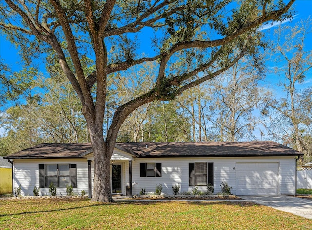 ranch-style home with a garage, driveway, and a front yard