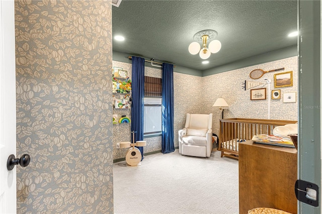 interior space featuring a textured ceiling and wallpapered walls