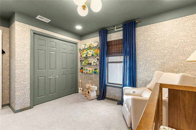 interior space with visible vents, carpet flooring, a textured ceiling, baseboards, and wallpapered walls